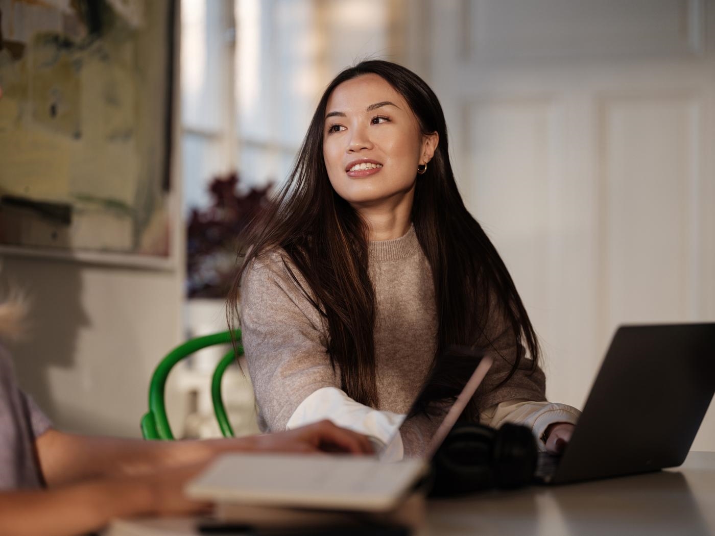 A young woman student studying with laptop at home