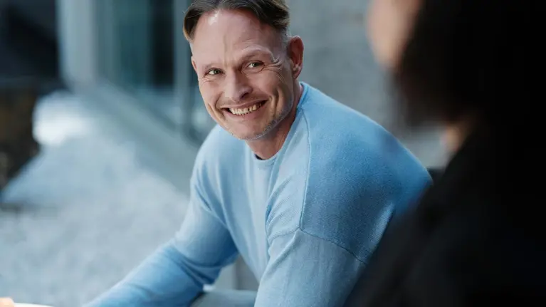 A smiling man portrait outside