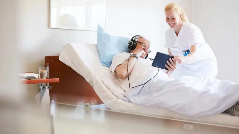 nurse looking at patients tablet