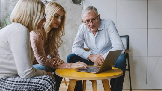 Grandparents Looking At Laptop
Young woman showing to senior couple something on a laptop