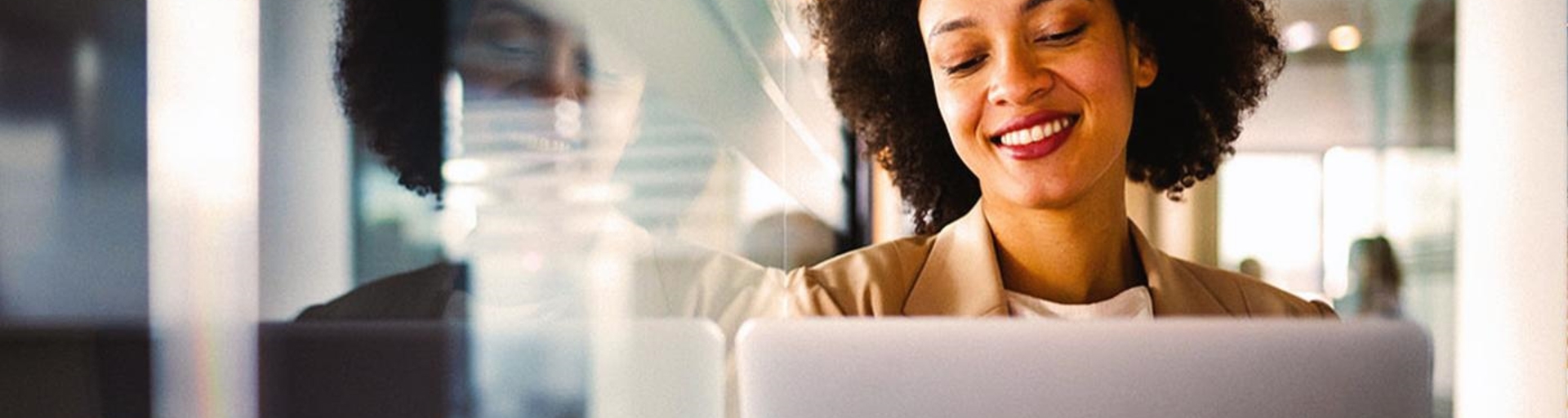 Young woman in online meeting on laptop smiling