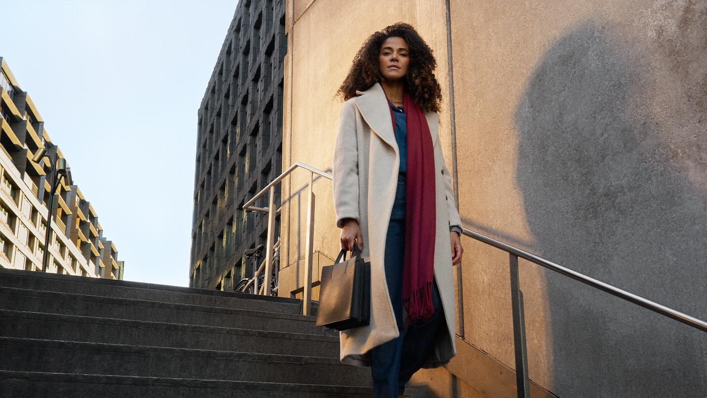 Young woman hero portrait in city urban environment